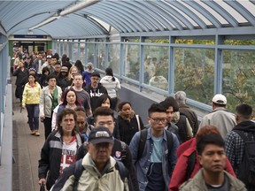 People stream off the SkyTrain at Metrotown in Burnaby in October 2015.
