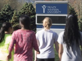 Students walk past a sign at Trinity Western University in Langley on Tuesday. A decisive legal victory, courtesy of the B.C. Court of Appeal, has put the evangelical Christian university one step closer in its bid to secure recognition for its proposed law school.