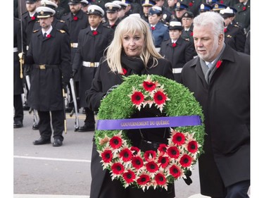 Quebec Premier Philippe Couillard, right, and government official Marie-Claire Ouellet place a wreath on the cenotaph during a Remembrance Day ceremony in Quebec City on Friday, November 11, 2016.