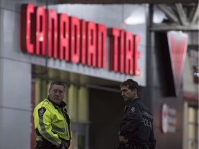 Police are seen outside the Canadian Tire store in East Vancouver following Thursday's attempted robbery and fatal shooting.