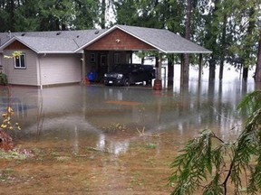 Floodwaters surround a home on Lakeshore Road near Port Alberni.