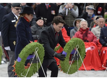 Prime Minister Justin Trudeau lays a wreath as Sophie Grégoire Trudeau looks on as they take part in the National Remembrance Day Ceremony at the National War Memorial in Ottawa on Friday November 11, 2016.