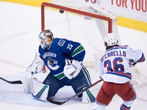 The Rangers' Mats Zuccarello scores the team's sixth goal against Canucks goalie Jacob Markstrom.