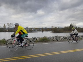 Bicycle riders make their way along River Road in Richmond where a group of cyclists was struck by a vehicle on Sunday.