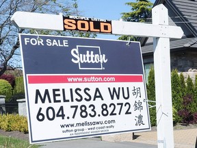 One of Melissa Wu's realtor signs. A serial vandal has been blacking out or cutting out her Chinese name.