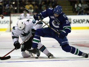 San Jose Sharks' Ryan Carpenter and Vancouver Canucks' Brandon Sutter, right, battle for the puck during a face off in the second period of NHL pre-season action at the Q Centre in Victoria, B.C., Monday, September 21, 2015.