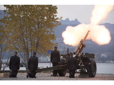 The Lions are seen in the background along the North Shore Mountains as a canon is fired off during the 21 gun salute during Remembrance Day celebrations in Vancouver, B.C., on Friday, Nov. 11, 2016.