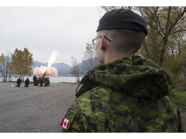 The Lions are seen in the background along the North Shore Mountains as a canon is fired off during the 21 gun salute during Remembrance Day celebrations in Vancouver, B.C., on Friday, Nov. 11, 2016.