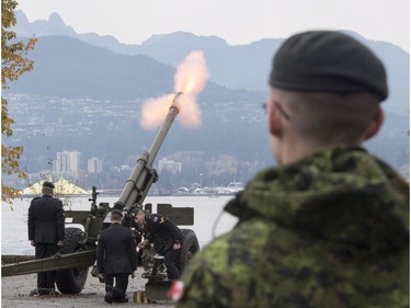 The Lions are seen in the background along the North Shore Mountains as a canon is fired off during the 21 gun salute during Remembrance Day celebrations in Vancouver, B.C., on Friday, Nov. 11, 2016.