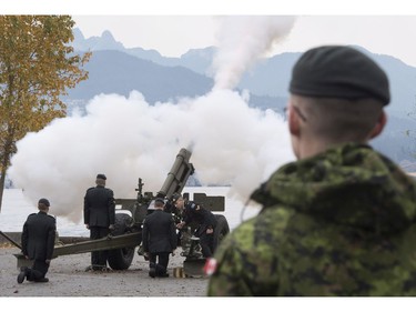 The Lions are seen in the background along the North Shore Mountains as a canon is fired off during the 21 gun salute during Remembrance Day celebrations in Vancouver, B.C., on Friday, Nov. 11, 2016.