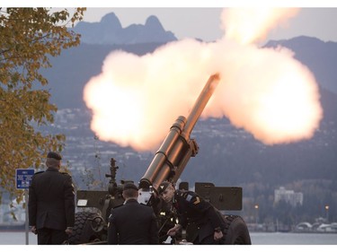 The Lions are seen in the background along the North Shore Mountains as a canon is fired off during the 21 gun salute during Remembrance Day celebrations in Vancouver, B.C., on Friday, Nov. 11, 2016.