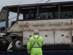 A review of bus companies in British Columbia has found the number of crashes involving motor coaches has declined by a rate that is ahead of the national average. A Commercial Vehicle Safety and Enforcement officer watches as a tour bus that rolled over and crashed on the Coquihalla Highway south of Merritt is moved during an investigation at a towing company lot in Kelowna, on Friday August 29, 2014.