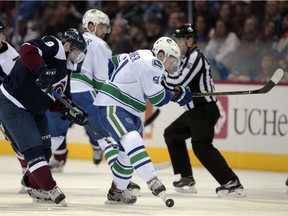 Troy Stecher kicks the puck away from Colorado Avalanche centre Matt Duchene on Saturday, when the Vancouver Canucks rookie defenceman played 24:30 in Denver.