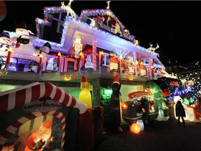 Families and locals take in the splendor of tens of thousands of lights and colourful characters lighting up the night outside a North Vancouver home in 2014.