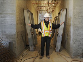 In 2011,  John Murnane  a manager with the Vancouver School Board points out two of the new concrete shear walls  that are part of the the seismic upgrades at Laura Secord Elementary.