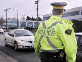 An RCMP traffic officer scans the traffic on Canada Way