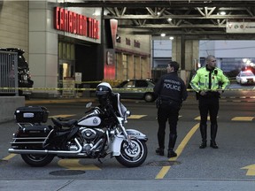 Police investigate a scene at Canadian Tire on Grandview Highway.