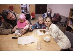 John, Kayla, Natalie and the baby enjoy breakfast at Strathcona Community Centre, adjoining Strathcona Elementary School in Vancouver. The program is supported by Adopt-a-School donations and is the largest free breakfast program for school children in the province.