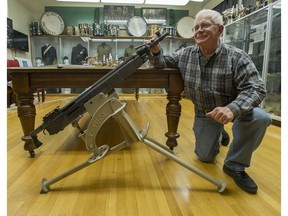 British Columbia Regiment unofficial historian Colonel (ret.) Keith Maxwell with a M1895 Colt-Browning .303-calibre machine gun at the Beatty Street armoury in Vancouver.