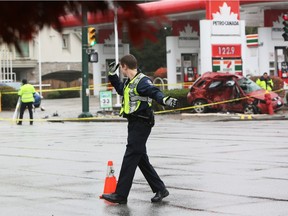 An officer directs traffic at the scene of a fatal car crash near West 41st Avenue and Oak Street in Vancouver on Nov. 14, 2015.