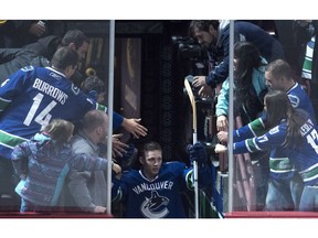 Vancouver Canucks defenceman Troy Stecher (51) greets fans as he is given the third star for the night after scoring his first NHL goal during NHL action against the Dallas Stars in Vancouver, B.C. Sunday, Nov. 13, 2016.