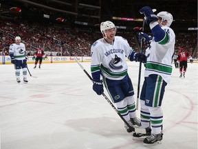 GLENDALE, AZ - NOVEMBER 23:  Alexandre Burrows #14 (R) of the Vancouver Canucks is congratulated by Sven Baertschi #47 after Burrows scored a goal against the Arizona Coyotes during the second period of the NHL game at Gila River Arena on November 23, 2016 in Glendale, Arizona.
