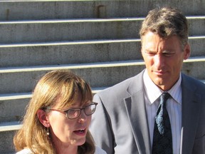 Vancouver Mayor Gregor Robertson looks on while the city's general manager of community services, Kathleen Llewellyn-Thomas, fields a question about the proposed empty-home tax at city hall on Sept. 14.