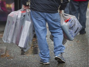 A heavily laden shopper in downtown Vancouver on Black Friday, 2014.