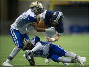 Twin brothers Tyson, left, and Jalen Philpot team up to take down GW Graham Grizzlies' Gabe Olivares in last Saturday's double-A semifinal at B.C. Place.