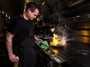 Cameron McKee, 25, cooks a steak at Chambar, a renewable natural gas customer of FortisBC.