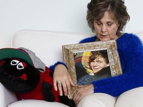 Marney Mutch holds a photo of her son Rhett, who was fatally shot by Victoria police in November of 2014. The red ladybug contains the ashes of her son. 
 Mutch is suing for wrongful death.