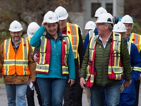 Premier Christy Clark adjusts her hard hat as she arrives for the announcement of Woodfibre LNG's funding approval for a $1.6-billion plant near Squamish.