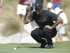 Tiger Woods lines up a putt on the first hole during the first round at the Hero World Challenge golf tournament, Thursday, Dec. 1, 2016, in Nassau, Bahamas. (AP Photo/Lynne Sladky)