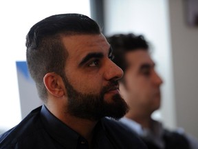 Abdurrahman Said, a recent refugee from Syria, speaks to the press after the Immigrant Services Society of British Columbia released a report on where Syrian refugees are at in terms of language ability, mental health, employment, and housing are after one year in the province.