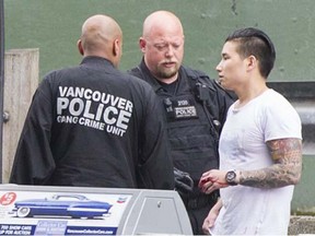 Jeffrey Chang with a VPD officer after a June 2014 shooting. He died July 2, 2015.