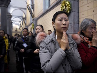 Chinese Christians attend Christmas Eve mass at a Catholic church in Beijing, on December 24, 2016.