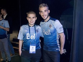 Kenton Doust with Vancouver Whitecaps midfielder Russell Teibert, who supported the teen during his recovery from brain cancer. Now. video game maker EA Sports has turned Kenton into a player in FIFA 17.