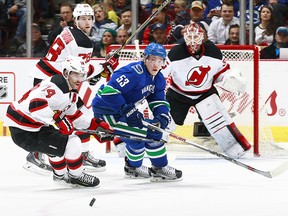 Bo Horvat chases the puck as Cory Schneider looks on during a November 22, 2015 game at Rogers Arena.