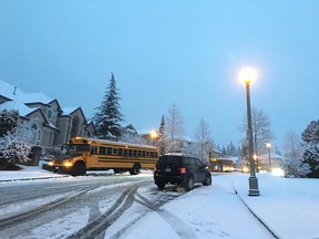 Buses and vehicles parked by the side of the road Monday morning while some braver drivers tried to inch their way down a hill in Coquitlam's Westwood Plateau area.