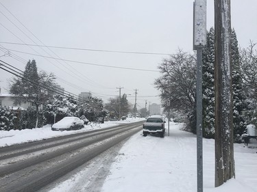 A street in Burnaby gets slushy as snow hits Metro Vancouver on December 9, 2016.