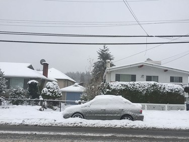 A car is covered with snow in Burnaby as snow falls in Metro Vancouver on December 9, 2016.