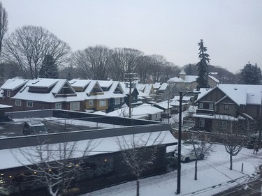 Rooftops of homes in Vancouver are seen covered in snow on December 9, 2016.