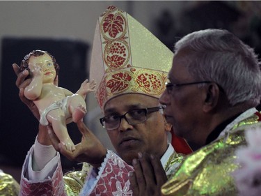 Clergymen celebrate Christmas mass at the Saint Joseph Cathedral in Allahabad late on December 24, 2016.