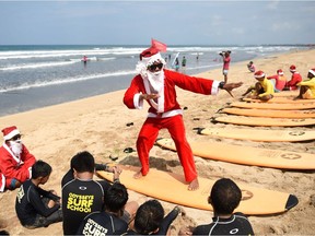 Christmas is a statutory holiday in Indonesia, the world's largest Muslim country. So is Easter. (Photo: Santa Claus surfer teacher on Indonesian island of Bali on  Dec. 19, 2016.