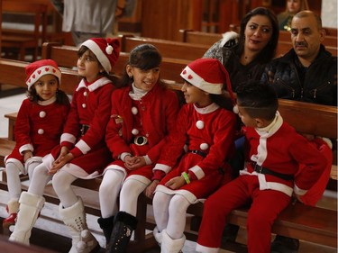 Iraqi Christians attend a Christmas Eve Mass at Our Lady of Salvation Church in Baghdad, Iraq, Saturday, Dec. 24, 2016.