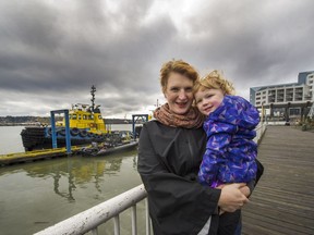 Sarah Kift with daughter Calliope at New West Quay. The Kifts left East Van for New West.