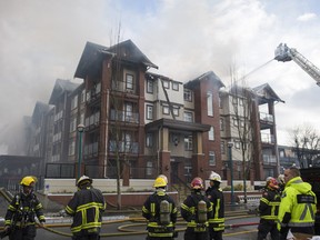 Firefighters battle a fire in the Paddington Station condo complex in the 5600 block of 201A Street in Langley