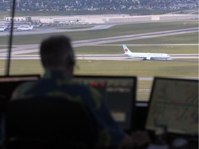 A Nav Canada air-traffic controller works at the Calgary International Airport. Transport Canada has fined the federal agency $85,000 for its lapse of medical certificates.
