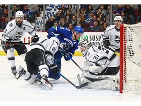 Peter Budaj of the Kings makes a save on the Canucks' Daniel Sedin.