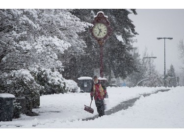 A man shovels snow at Queen Elizabeth Park in Vancouver, B.C., on Monday December 5, 2016. Environment Canada has issued a snowfall warning for Metro Vancouver.